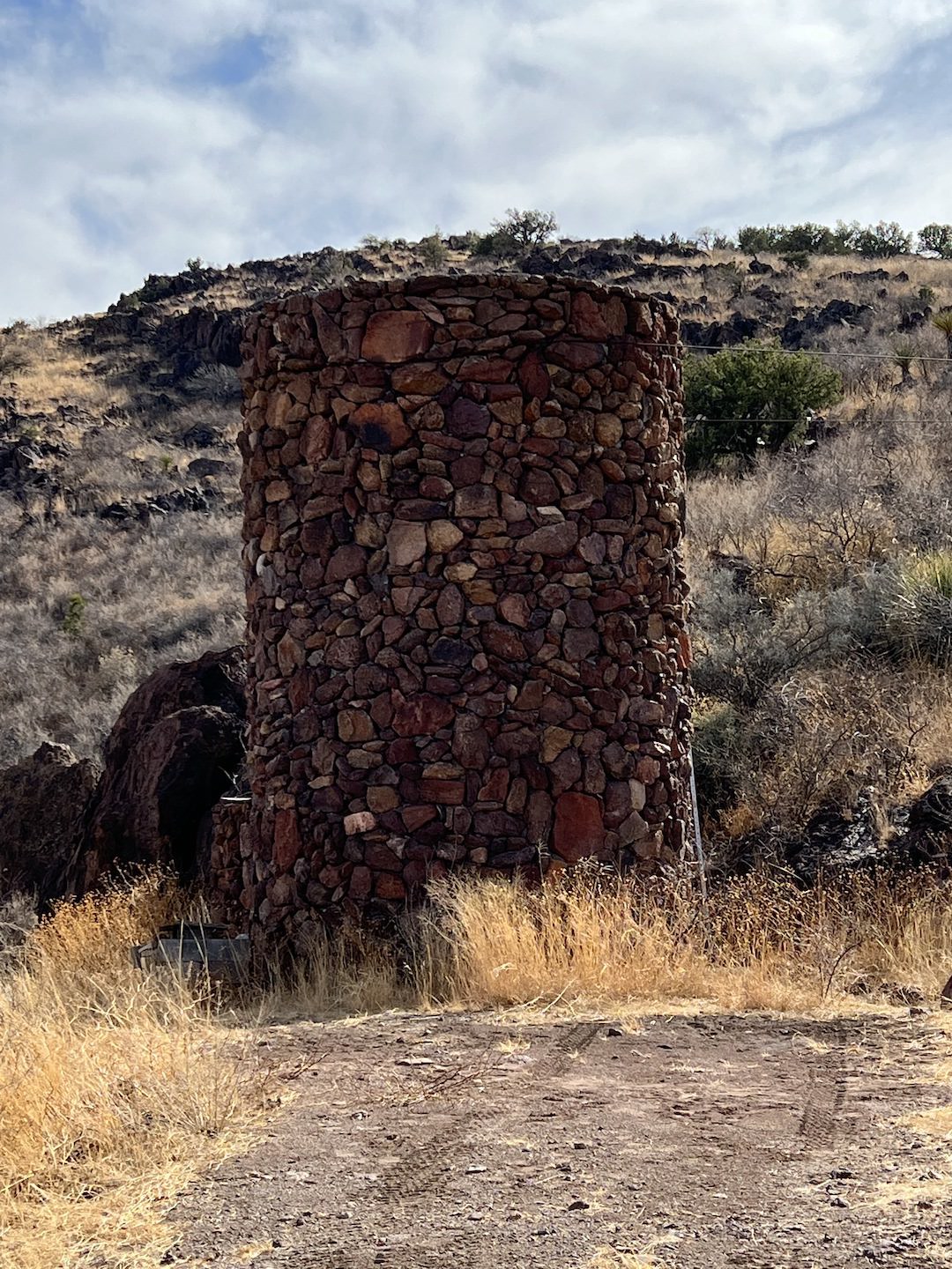 a stone water tank on a ranch